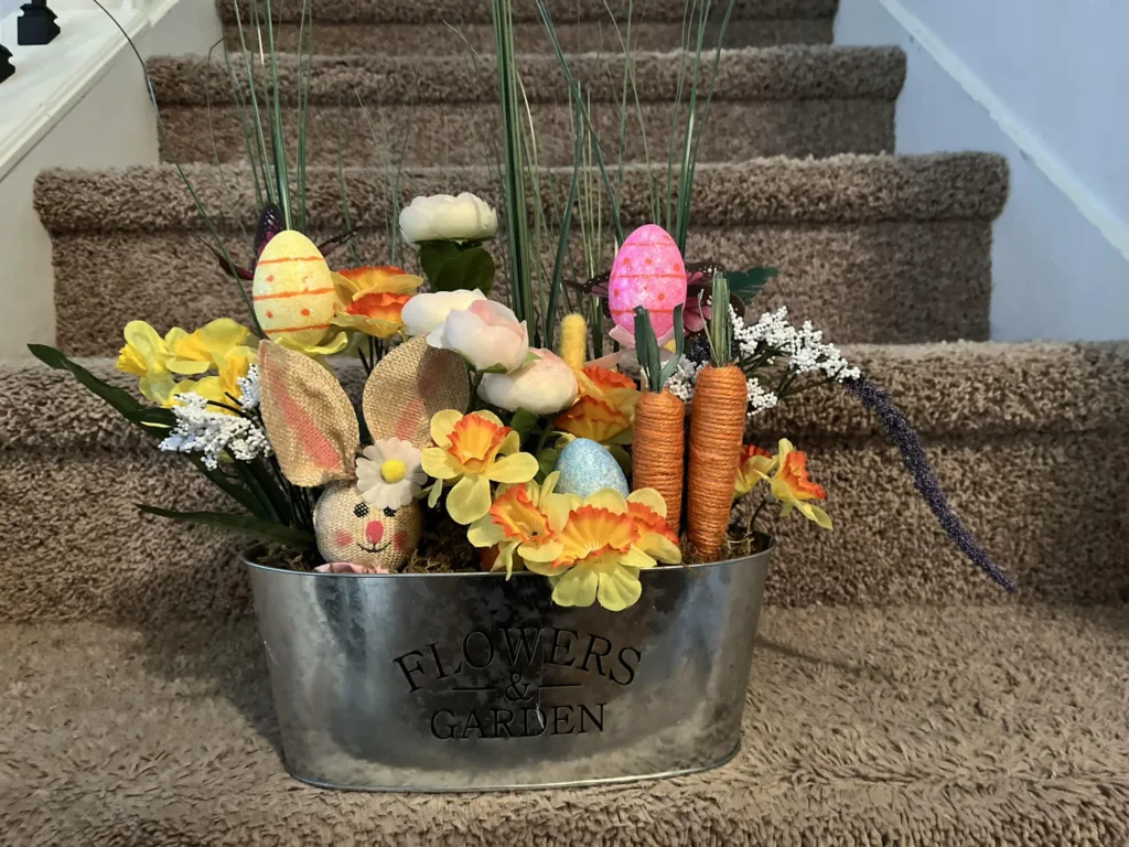 DIY bunny face floral arrangement with flowers and decorative eggs made from Dollar Tree items.