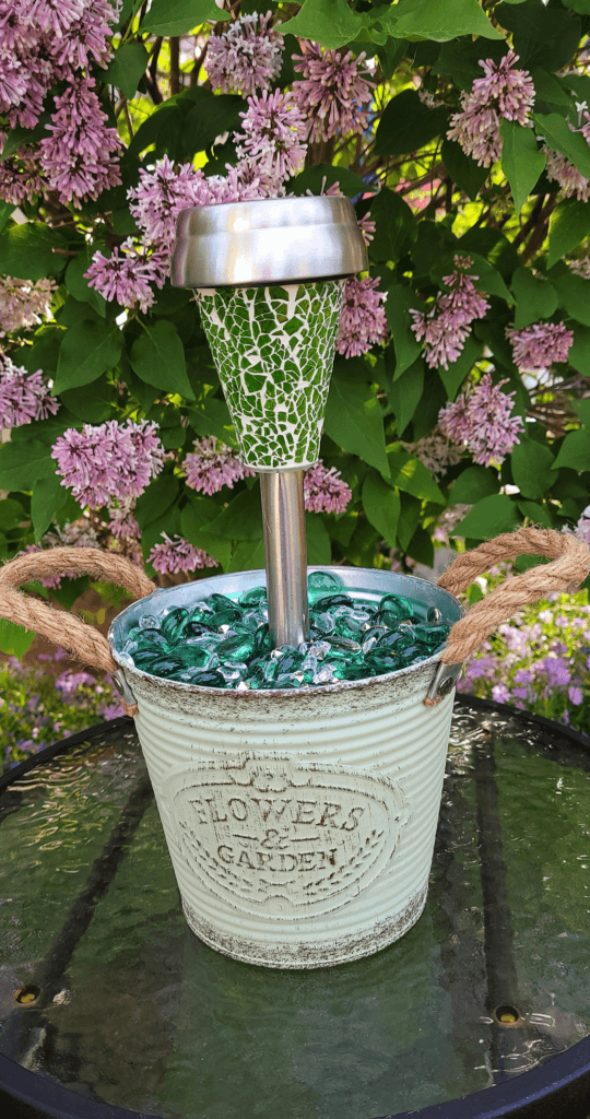 Various DIY garden ornaments made from Dollar Tree products, including solar lights and decorative containers.