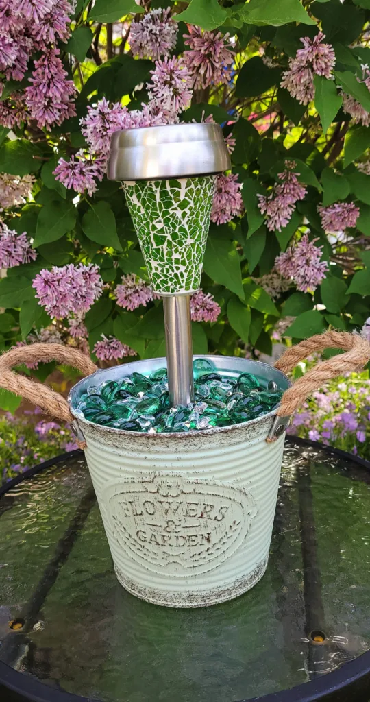 Various DIY garden ornaments made from Dollar Tree products, including solar lights and decorative containers.