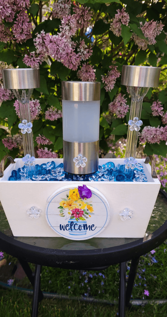 Different DIY garden decorations with solar lights and glass gems.