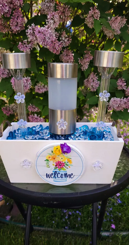 Different DIY garden decorations with solar lights and glass gems.