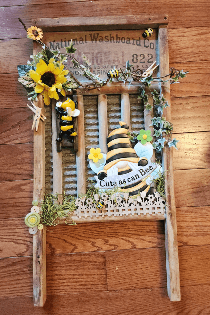 Detailed view of the bee-themed garden decoration with gnome, bees, and greenery.