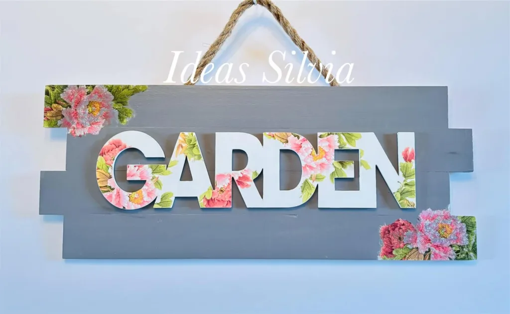 DIY garden sign made from wooden boards and decorated with floral napkins.