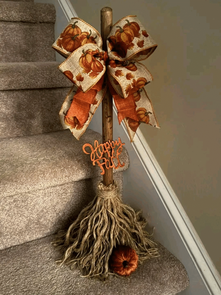 DIY Happy Fall broom made from Dollar Tree mop head with pumpkin ribbon and seasonal sign