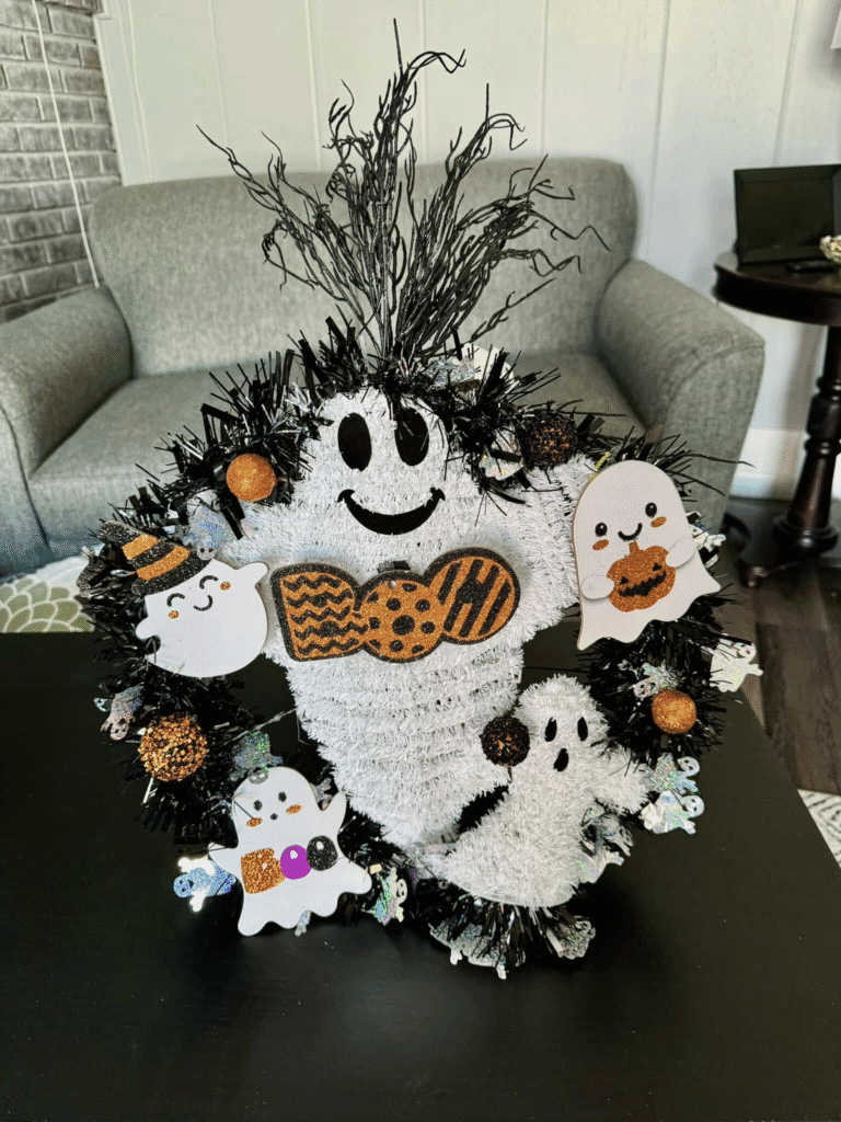 DIY Halloween wreath with cute ghost decorations, black and white tinsel, and glittery ornaments