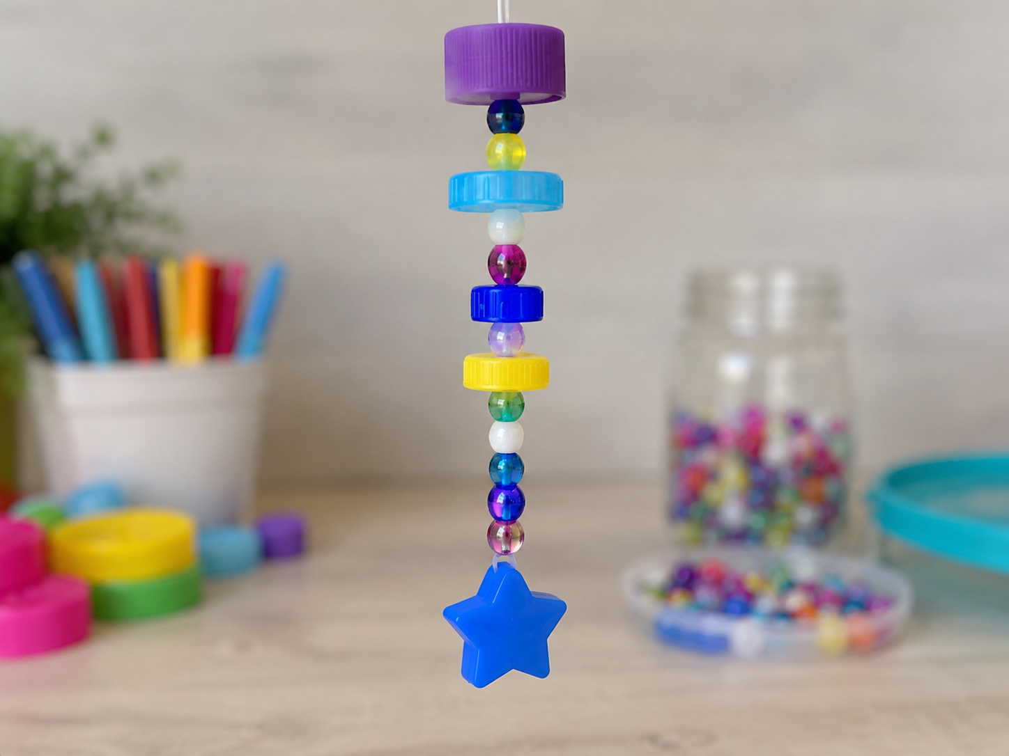 How to add weighted bottoms - Cheerful Upcycled Bottle Cap Wind Chime DIY tutorial