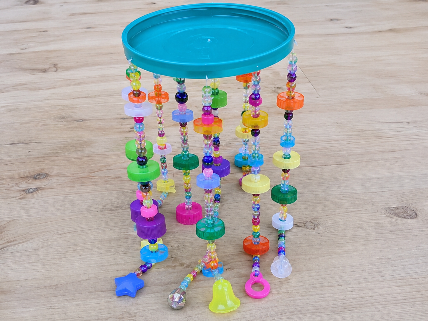How to attach strands to base - Cheerful Upcycled Bottle Cap Wind Chime DIY tutorial