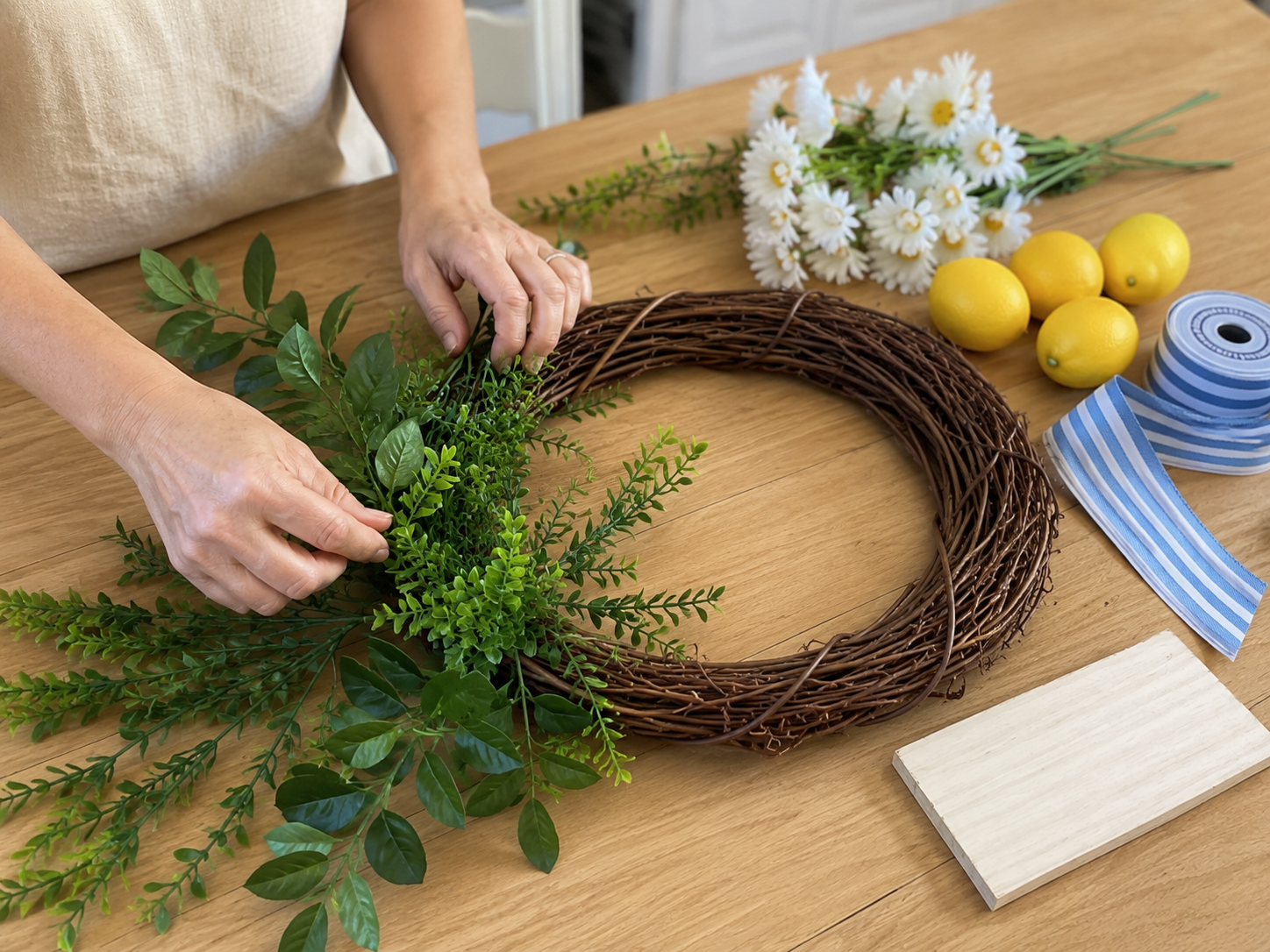 How to secure greenery in place - Sunshine & Stripes: Easy Dollar Tree Summer Wreath DIY tutorial